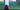 Person walking past a green tiled wall with a blurred effect